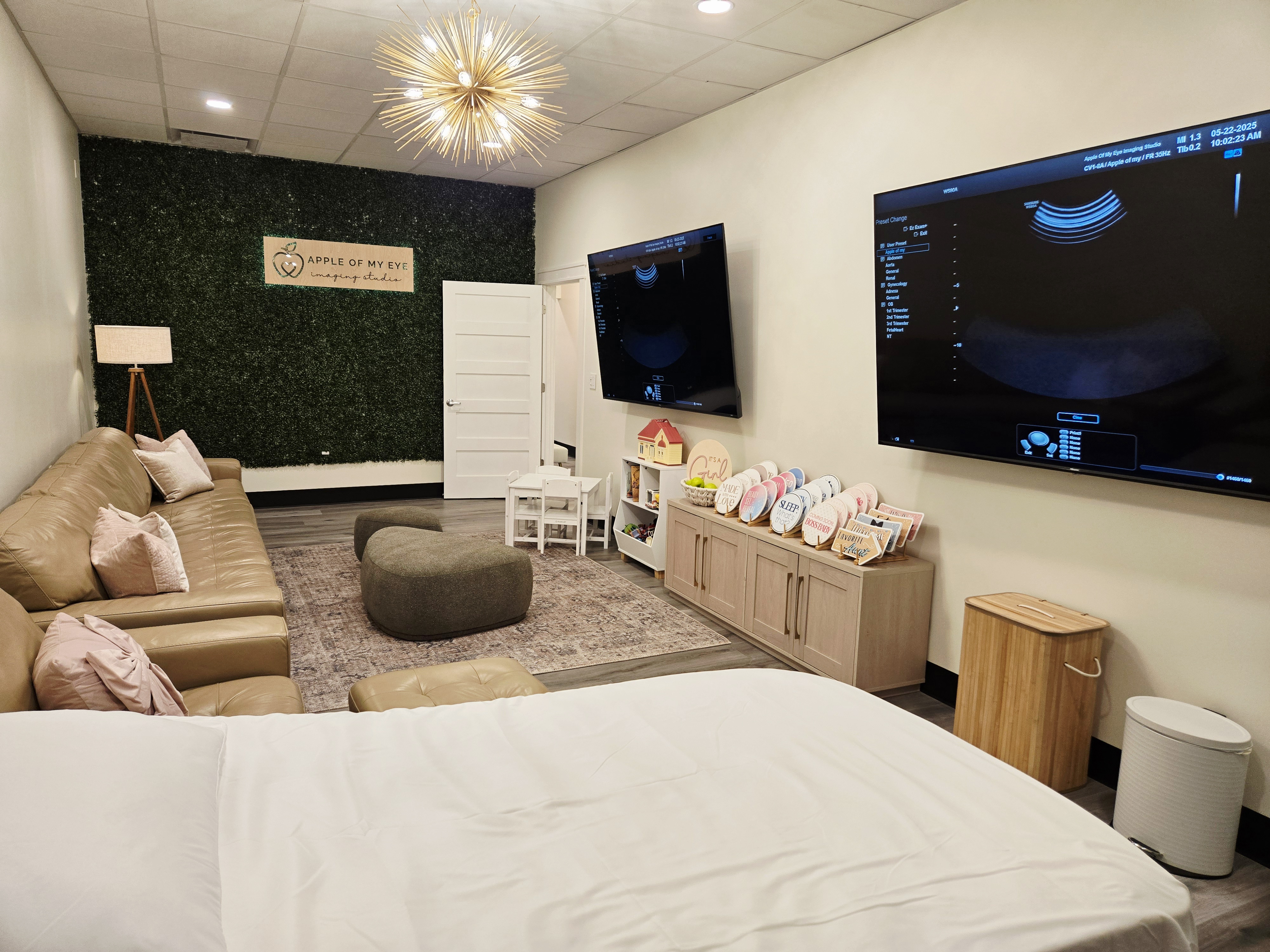 Modern ultrasound room with dual screens and comfortable seating